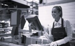Supermarket worker measuring and selling meat to the customer.